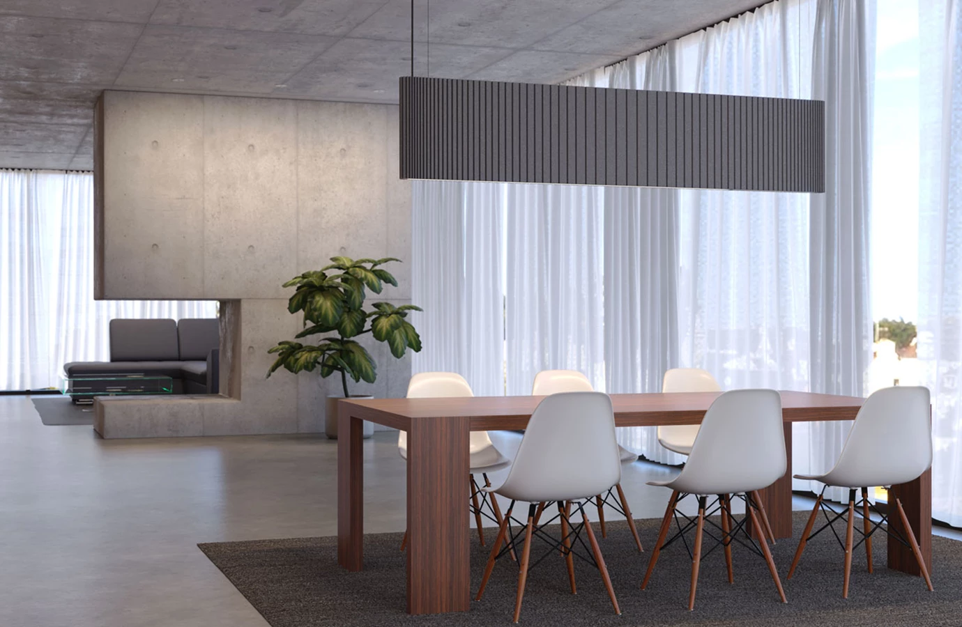 Luz colgante acústica para espacios de vida elegantes y con ruido reducido. Luminaria ovalada gris sobre la mesa del comedor.