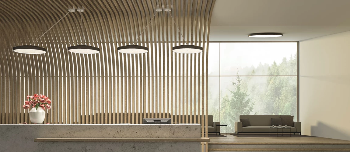 A round SIGN DIVA pendant luminaire provides stylish and harmonious lighting in the reception area of a doctor's office.