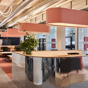 Open-plan office with acoustic luminaires for optimal room acoustics and glare-free workplace lighting.