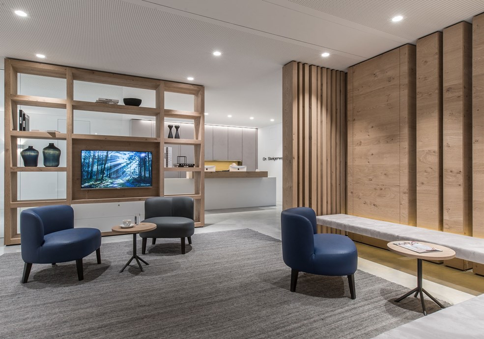 Discreet recessed ceiling spots provide even, glare-free light and create a pleasant atmosphere in the waiting room of a doctor's office.
