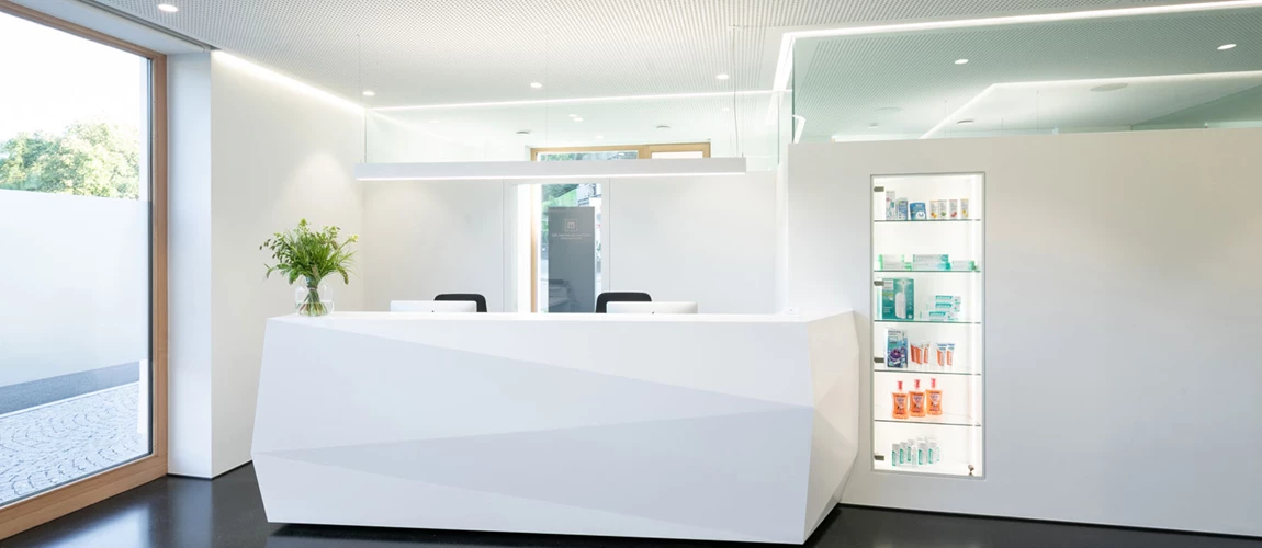 Bright and modern ceiling lighting in the reception area of a doctor's office creates a friendly atmosphere for patients and visitors.